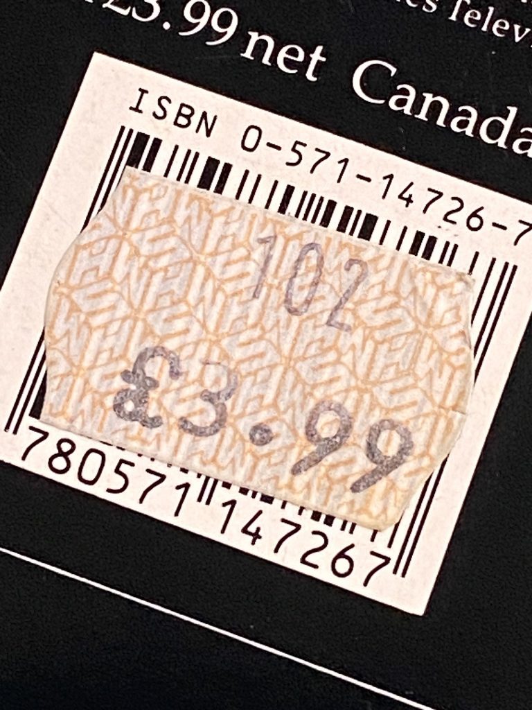 An old WHSmith price sticker with text reading 102 (the till code) and the reduced price of £3.99. The WHSmith cube logo can be seen in the background